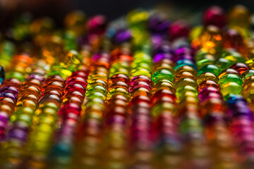 Fototapeta na wymiar Selective focus shot of some Colorful Water Beads staged in colorful light in close-up