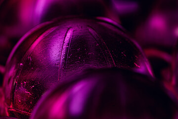 Shallow focus closeup of purple packaging waste staged in colorful light