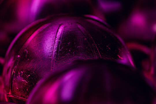 Shallow focus closeup of purple packaging waste staged in colorful light