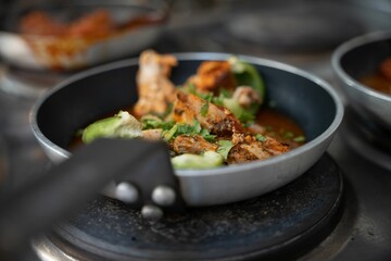 a bowl of soup sitting on top of an oven burner