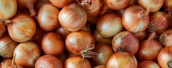   A pile of onions stacked upon one another, atop another pile