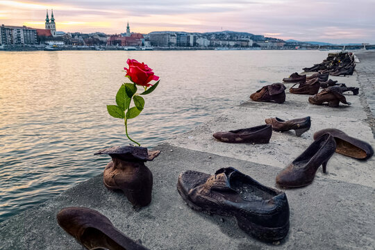 "Shoes on the Danube bank" - Monument as a memorial of the victims of the Holocaust during WWII on the bank of the Danube at sunset in Budapest, Hungary