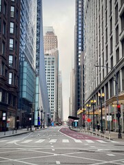 view of a street in downtown Chicago in the Loop district with road traffic and buildings on a cold...