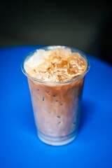 cold coffee in the evening in a coffee shop on a blue table