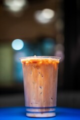 cold coffee in the evening in a coffee shop on a blue table