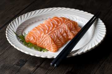 Close-up of sliced salmon on white dinner plate, Japanese food sashimi