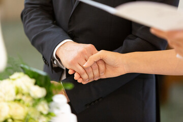 newlyweds holding hands during their wedding ceremony