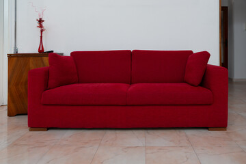 modern red fabric sofa in a minimalist interior