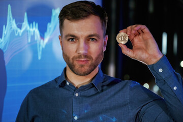 Coin of digital currency in hand. Business coach against projector with data