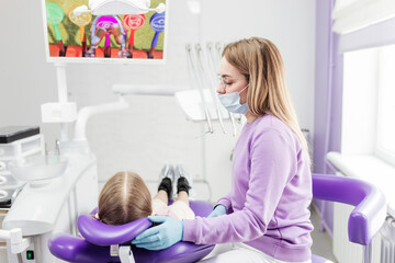 dentist prepares patient before examination, pediatric dentistry
