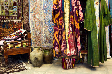 Street market in Bukhara - beautiful Uzbek handmade carpets and antique pottery - obrazy, fototapety, plakaty