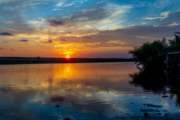 Fototapeta na wymiar Evening sky reflection on river water