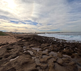 A Harmonious Tapestry of Sand, Rocks, Beach, and Endless Blue Skies