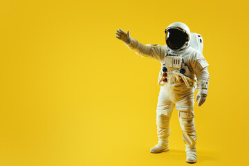 An astronaut in full gear stands with arm extended, evoking themes of space exploration and discovery on a vibrant yellow background