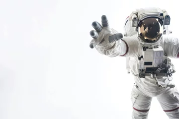 Poster Capturing the essence of space travel, this image features an astronaut reaching towards the viewer on a stark white background © Fxquadro
