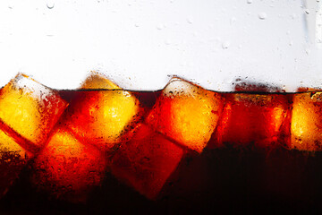 Cola drink and ice cubes close-up,Ice cubes in cola beverage, close up