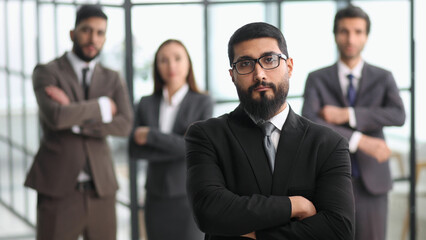 positive employee posing for company business catalogue with colleagues at background, having photo...