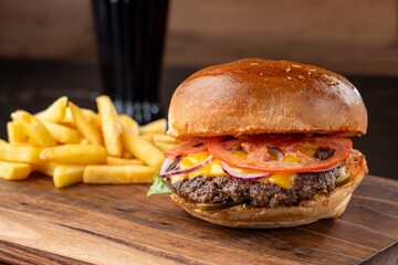 Burger on a wooden board with drink