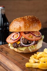 Burger on a wooden board with drink