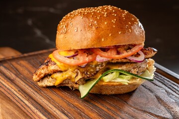 Burger on a wooden board with drink