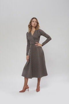 Serie of studio photos of female model in patterned brown midi dress, autumn winter fashion collection.