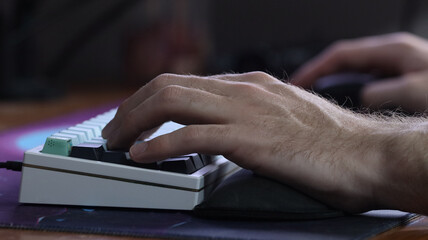 Hands typing on a computer keyboard