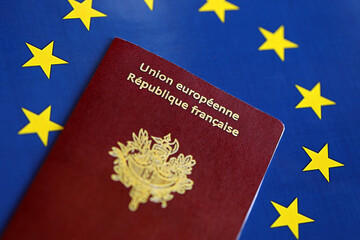 French passport of European Union on blue flag background close up. Tourism and citizenship concept - obrazy, fototapety, plakaty