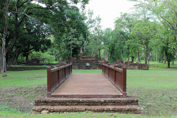 Fototapeta premium Bridge to Wat Nang Phaya, Si Satchanalai Historical Park, A historical park in Si Satchanalai district, Sukhothai Province, Northern Thailand