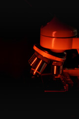 Fototapeta na wymiar Medical microscope lenses close up, In warm red lighting