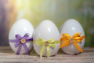 3 Eggs wrapped in a colorful gift tie. Easter, Pascha or Resurrection Sunday concept
