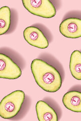 Composition made of avocado and disco ball on pastel pink background. Creative concept. Flat lay.