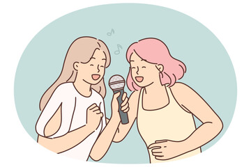 Two women sing song in karaoke at house party. I get positive emotions from musical leisure
