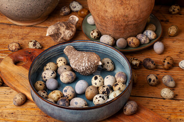 A vibrant display of natural quail eggs, resting on a rustic wooden surface.