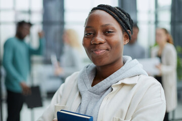 Female African American job seeker keeping a folder with CV