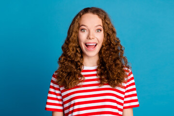 Photo of impressed overjoyed woman with wavy hairstyle dressed striped t-shirt astonished staring...