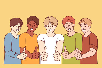 Multiethnic men students show thumbs up as sign of solidarity and affirmation absence of interracial problems in society. Multicultural guys in casual clothes making affirmation gesture