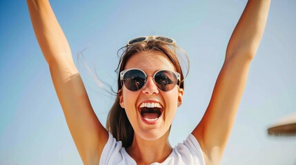 young happy smiling attractive woman arms raised up and cheering, blue sky in the background, sunny day, 16:9