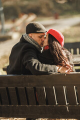 A Middle-Aged Couple Kissing on a Park Bench