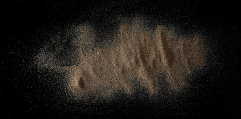 Sand scattered isolated on black background and texture	