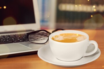 A cup of tasty aroma hot cappuccino at work place