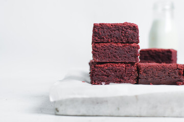 red velvet brownies on a white marble tray, red velvet fudge brownies on a white background