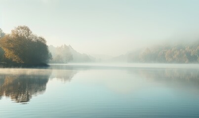 Fototapeta na wymiar The lake shrouded in mist during a crisp autumn morning