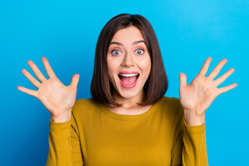 Photo of excited cheerful woman wear shirt smiling open mouth rising arms palms isolated blue color background - obrazy, fototapety, plakaty