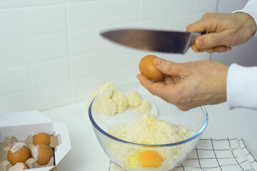 Person Holding Knife Over Bowl of Eggs