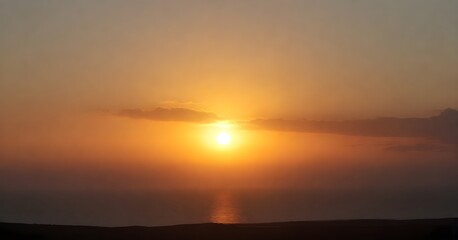 Stunning landscape of a golden sun setting over the horizon of a tranquil blue ocean