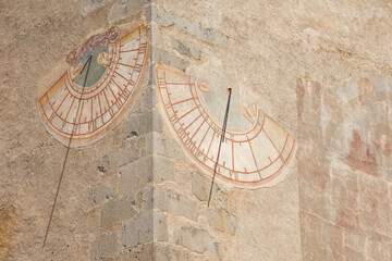 The recently restored sundial painted outside the bell tower of the church of the town in Villandro.