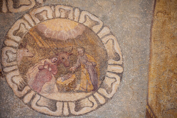 the recently restored historical paintings on the external walls long the way of the center of the little mountain town