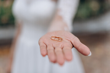 close up view of hand holding wedding rings