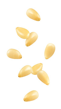 Falling Pine nuts isolated on white background, full depth of field