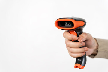 A person is holding a black and orange barcode scanner.